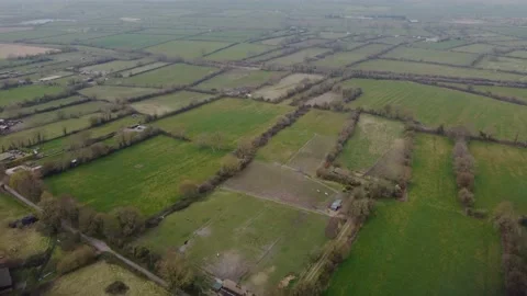 A slow flight over the patchwork of fields in Wiltshire UK Video stock 172492335