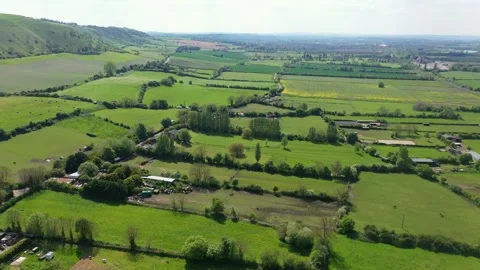 Slow flight over a patchwork of fields in England. Sunshine. Video stock 274747010
