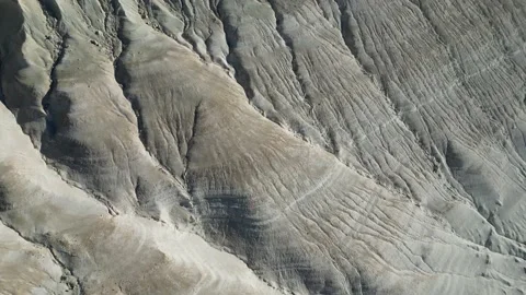 Slow flight over the peaks of mountains and hills in the mountain desert Stock Footage 238191826
