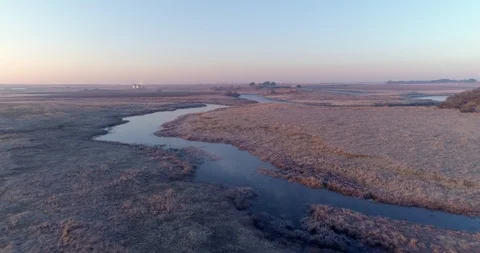 Slow flight over river at dawn with mild mist rising from water Stock Footage 93484692