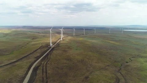Slow flight over a wind farm from a bird's eye view Stock Footage 153445806