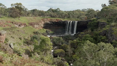 Slow Flight Past Cliff and Trees Reveals Wannon Waterfall in Victoria Australia Stock Footage 249640930