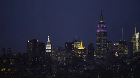 Slow flight past Manhattan skyline at night; Williamsburg Bridge passes through Stock Footage 59171685