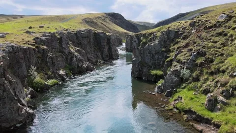 Slow flight through a canyon with blue water below, 4K Video stock 138314359