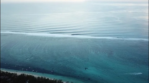 Slow flight towards distant waves in Mauritius Stock Footage 113476808