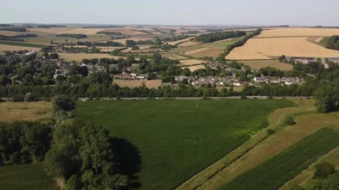 Slow flight towards the village of Codford in the Wylye Valley, Wiltshire 動画素材 339497324