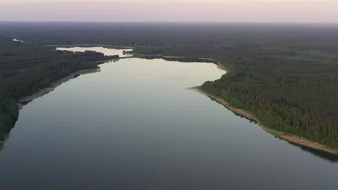 Slow fly over moody calm gutter lake at sunset Stock Footage 194703455