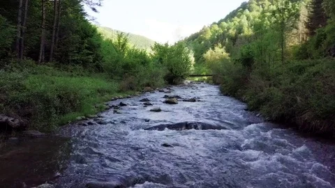 A slow fly over a rushing river stream Stock-Footage 76798560