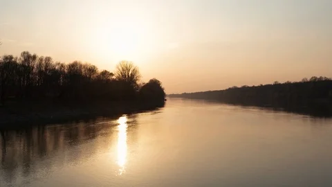 Slow flying above river at Sunset Time. Beautiful Golden Hour with clear sky 4k Stock Footage 127536968