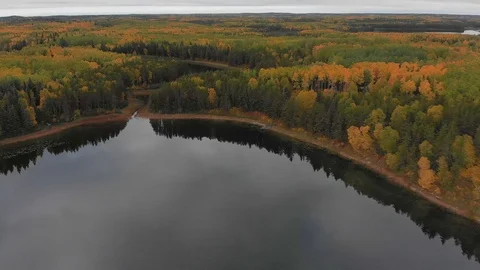 Slow flying drone over large calm lake with clouds reflecting in the water. Stock Footage 116731553