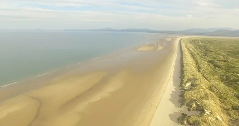 Slow flying over Harlech Beach and sand dunes Stock Footage 90059361