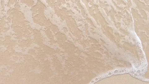 Slow foamy waves movement at yellow sand Stock Footage 131175927