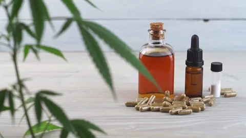 Slow focus from Cannabis leaf and CBD oil, pills and CBD crystals isolate Stock Footage 107039295