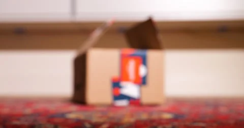Slow focus to open Amazon winter holidays gift package parcel Stock Footage 230477884