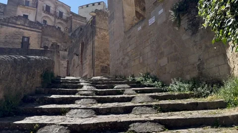 Slow Forward Camera Move Up Historic Stone Stairway in Sassi di Matera, Italy Stock Footage 336674574