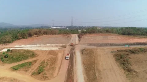 Slow forward drone shot of dump trucks on construction site Stock Footage 346189791