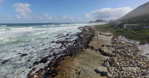 Slow forward flight over rocky shoreline and rough seas. Cape Town, South Africa Stock-Footage 65805024