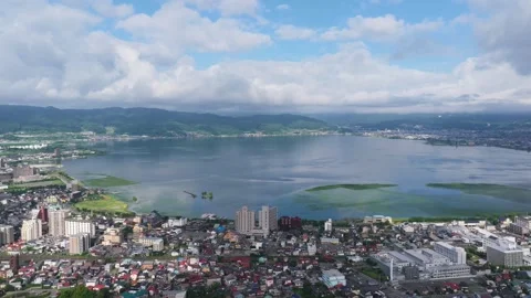 Slow Forward View Over Lake Suwa and Nagano Shoreline Stock Footage 342320601
