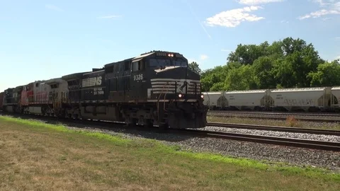 Slow Freight train passing faster train, inclides rare Santa Fe locomotive Stock Footage 81922560