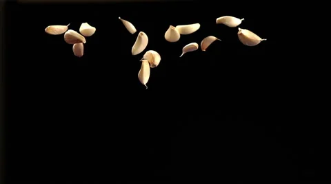 SLOW: Garlic fly up and fall Stock Footage 49065351