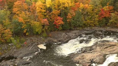 Slow gliding motion made by drone flying over fall river at low level Stock Footage 119187963
