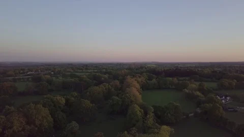 Slow gliding shot over trees and countryside Video stock 98825075