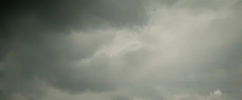 Slow grey puffy clouds anamorphic Stock Footage 242790960