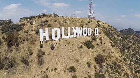 Slow high to low pull back away from Hollywood Hills sign on bright sunny Stock-Footage 99382386