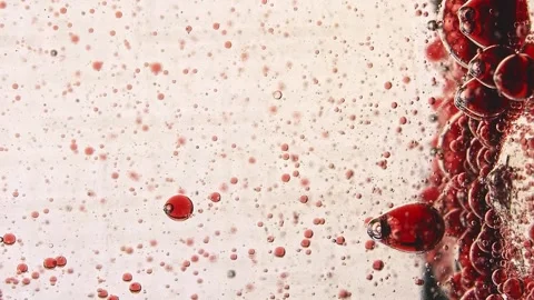 Slow horizontal movement of drops of one liquid in another Stock Footage 132188727