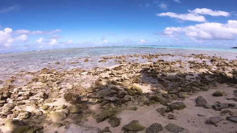 Slow horizontal view of sandy rocky beach of Koromiri look out to horizon and an Stock Footage 250401475