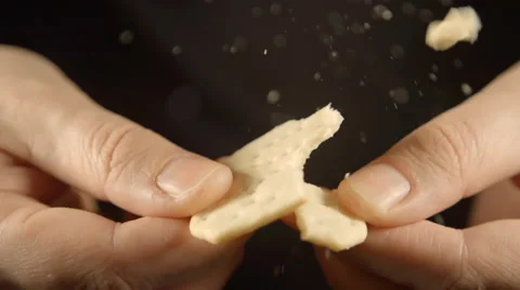 SLOW: A human hands break a cookie Stock Footage 61033441