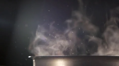 Slow Jet of steam and small drops  from a pan.  Stock Footage 72249216