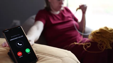 Slow knitting during digital detox in a cozy living room with a ringing Vídeos de archivo 346147237