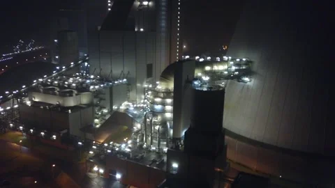 Slow lateral drone move across illuminated cooling tower pipe Stock Footage 343736628