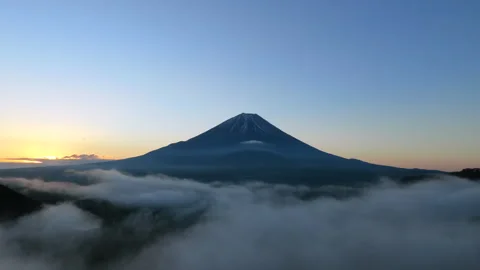 Slow Left Orbit Around Mount Fuji Above Sea of Clouds at Sunrise 4K Drone Stock Footage 339650653