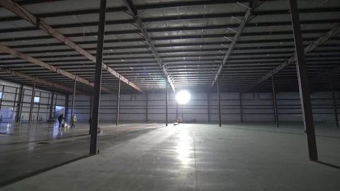 Slow Left Pan of Construction Workers Working on Cement Floor Stock-Footage 101390496