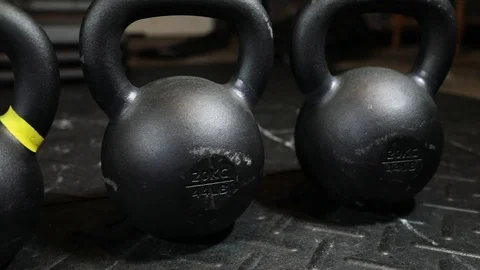 Slow Left to Right Kettlebell Tracking Shot in Garage Gym Stock Footage 116499983