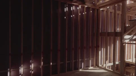Slow Left to Right Pan of Interior House Framing with Staircase Stock Footage 334583328