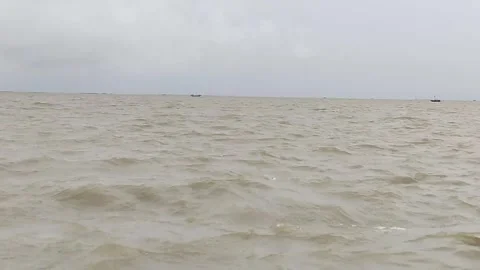 Slow Left to Right Pan of River Waves and Cloudy Horizon – 4K Nature Footage Stock Footage 339014307