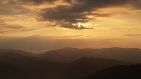 Slow left right track of mountains and early morning sky and sun Video stock 246646982