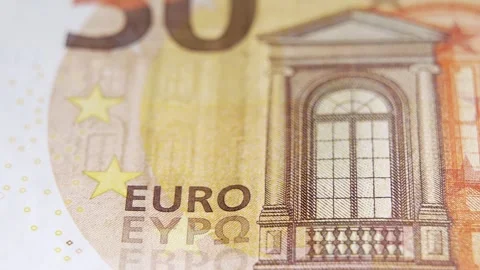 Slow macro pan along a 50 euro note, highlighting the EURO text, stars, and fine Stock Footage 322925914