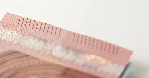 A slow macro tracking shot across a stack of Euro Notes Stock Footage 88488000