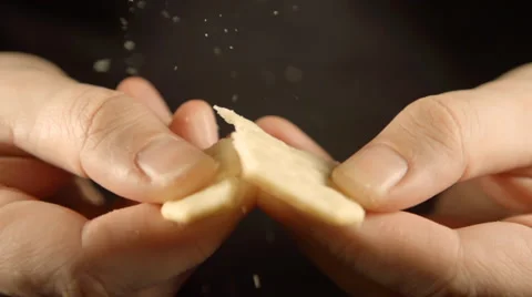 SLOW: A man hands break a cookie Vídeo Stock 61631075