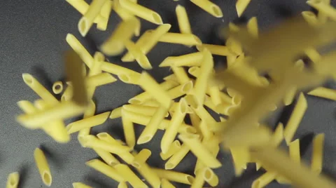 SLOW: Many of noodles fall on a black table (top view) Stock Footage 64333573