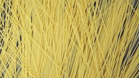 SLOW: Many of spaghetti fall on a black table (top view) Vídeo Stock 64333593