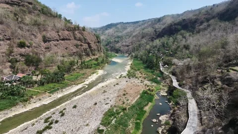 Slow mo aerial drone flying over rocky river valley in dry season. 스톡 동영상 344956314