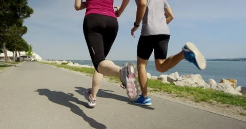 Slow Mo Of Athletic Couple Running Shot In Their Backs Stock Footage 123734558