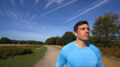 Slow Mo Attractive Man Running in Park on Sunny Day Stock Footage 96046901