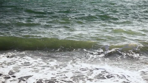 Slow mo azure wave crawls ashore Stock Footage 82384778