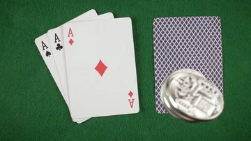 Slow mo bitcoins fall on four cards top view Stock Footage 85642324
